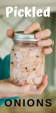 a person holding a jar with onions in it and the words pickled on top