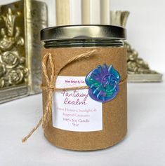 a candle with a tag on it sitting next to some candles