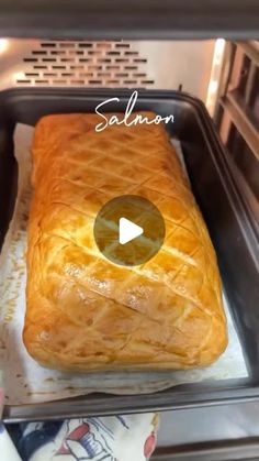 a loaf of bread sitting on top of a pan in an oven with the words salmon written above it