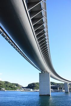 the underside of a large bridge over water