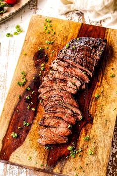 a steak on a cutting board with parsley