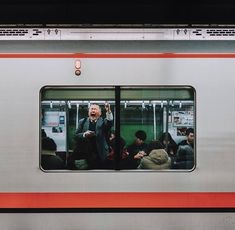 people are sitting on the train and looking out the window as it passes by them