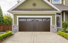 a large house with two garages in front of it