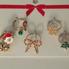 six rings with christmas decorations on them and a red ribbon tied to the top one