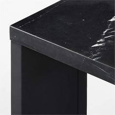 a black marble top desk against a white background with the corner section showing it's edge