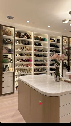 a room filled with lots of shoes and vases on top of a white counter