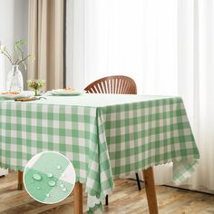 a green and white checkered table cloth on top of a wooden chair next to a window