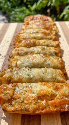 several slices of pizza sitting on top of a wooden cutting board