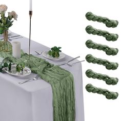 the table is set with green napkins and flowers on it, along with candles