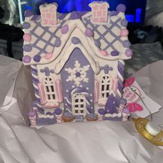 a purple and white gingerbread house with snowflakes on it