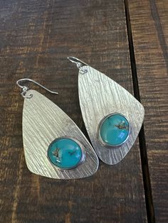 These eye catching high shine Kingman Turquoise earrings will be your favorites! There are sterling silver, 1.25” wide and a just about 2.25” long. Not too heavy dispute the good size! Modern Turquoise Nickel-free Earrings, Modern Teardrop Turquoise Jewelry, Kingman Turquoise, Turquoise Earrings, Stone Earrings, The Good, Turquoise, Sterling Silver, Stone