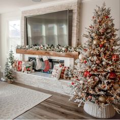 a decorated christmas tree in front of a fireplace