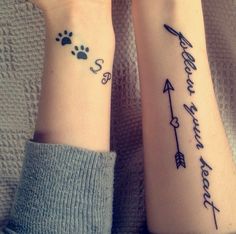 two people with matching wrist tattoos on their arms, one has an arrow and the other has a paw print