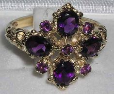 *This ring is made from 375 9K (9ct 9Kt) Yellow Gold with Genuine Amethyst.*Total Height 4mm, Width 15mm, Length 17mm Like all my jewelry pieces, this ring is made in my own workshop. PLEASE MAKE SURE YOU STATE THE FINGER SIZE YOU REQUIRE WITH YOUR PAYMENT AND ALSO INCLUDE YOUR TELEPHONE NUMBER FOR DELIVERY COURIER.This truly elegant English ring has been set with four 5x4mm (0.2"x0.16") oval cut five 2mm (0.8") round cut, Fabulous Deep Purple Amethysts all set in this stunning Solid 9K Yellow G Regal Rings, Amythest Jewelry, Rhombus Ring, Amethyst Ring Engagement, Morganite Engagement, Amethyst Jewelry, Victorian Style, Solid Yellow, Purple Amethyst