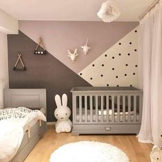 a baby's room decorated in grey and white