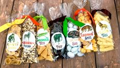 several bags of snacks sitting on top of a wooden table