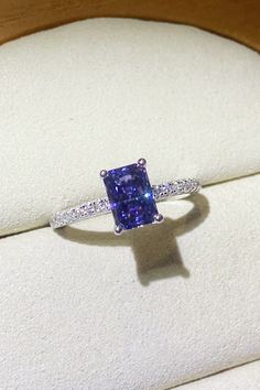 a ring with a blue and white diamond in it