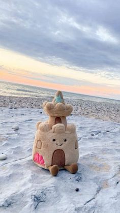 a sand castle sitting on top of a sandy beach