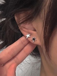 a close up of a person's ear with two small stars on the side