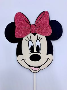 a minnie mouse cake topper on a stick