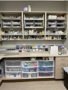 a medical room with several shelves and bins