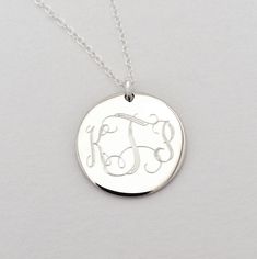 "Monogram Necklace - Wedding Jewelry This sterling silver monogram necklace is a beautiful present for high school or college graduation that is sure to be cherished for a long time to come. I will engrave a monogram or name onto the round pendant. Pendant available in 2 sizes (3/4\" or 1\") **Please provide initials in the order you would like them engraved, for Interlocking Monogram it should be First, Last, Middle.** Pendant - Sterling Silver, 3/4\" diameter or 1\" diameter Necklace- Sterling Sterling Silver Initial Necklace With Name, Classic Personalized Medallion Jewelry, Classic Initials Name Necklace For Anniversary, Silver Initial Pendant Name Necklace For Anniversary, Elegant Silver Monogram Initial Necklace, Elegant Silver Initial Necklace With Monogram, Elegant Silver Initial Necklace For Anniversary, Classic Sterling Silver Initial Pendant Name Necklace, Classic White Gold Monogram Initial Necklace