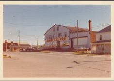 an old photo of the corner of a street