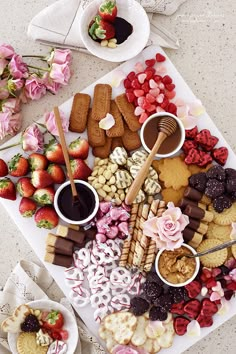 a platter filled with lots of different types of snacks and desserts on plates