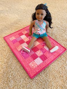 a doll sitting on top of a pink rug