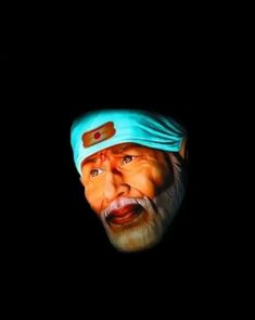 an old man with a blue headband on in the dark, looking at something