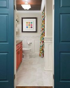 an open door leading to a bathroom with white walls and blue trim on the doors