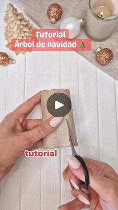 someone is using scissors to cut out the paper for an ornament craft project