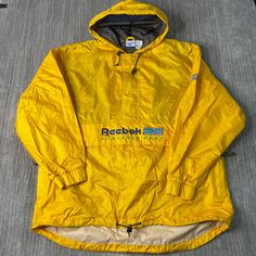 Vintage 2000s Reebok Kangaroo Pouch Sportswear Athletic Y2K Aesthetic Windbreaker Yellow Pullover Hooded Jacket Extra Large Mens Condition: Fair Used Condition = Has stains on the back shoulder of the jacket due to wear and age, Measurements: Please see photos above for all measurements IF YOU BUY TWO OR MORE ITEMS USE THE CODE BUNDLE @ CHECK TO SAVE 20% WE SHIP WITHIN 24 HOURS AFTER PURCHASE! Please be aware that we do not offer free returns!! The Buyer is responsible for the cost of the return Sporty Windbreaker With Kangaroo Pocket For Outdoor Activities, Sports Windbreaker With Kangaroo Pocket And Long Sleeves, Casual Sports Windbreaker With Kangaroo Pocket, Casual Windbreaker With Kangaroo Pocket For Sports, Sporty Windbreaker With Kangaroo Pocket For Streetwear, 90s Hooded Windbreaker For Hiking, Sporty Windbreaker With Kangaroo Pocket, Sportswear Outerwear With Kangaroo Pocket, Sporty Outerwear With Kangaroo Pocket For Sports