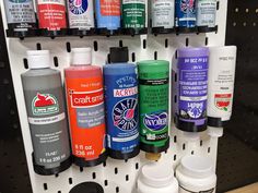 many different types of paint are on the shelf