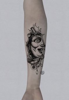 a person with a tattoo on their arm that has an evil clown face in it