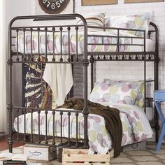 a bedroom with a metal bed frame next to a brick wall and a clock on the wall