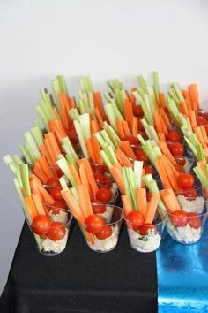 an image of carrots and celery in small cups with tomatoes on them