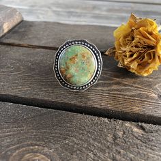 "This Kingman Turquoise stone has such an earthy vibe, perfect for fall. It's set in a silver beaded border which has been oxidized to show off the details and it has a simple, slightly hammered sterling silver shank in a size 8.5-8.75. The face measures 1.1\" Ring Size 8.5-8.75 Turquoise is known as the master healing stone. Attributed to the power of connecting mind, body, and soul, it is also a symbol of superior energies and spiritual openness What do you receive when you purchase from Crims Bohemian Adjustable Turquoise Ring, Adjustable Bohemian Turquoise Ring, Adjustable Green Turquoise Ring With Natural Stones, Bohemian Turquoise Ring With Natural Stones, Bohemian Turquoise Ring, Green Turquoise Ring With Natural Stones, Artisan Green Turquoise Ring One Of A Kind, Bohemian Turquoise Ring With Natural Chrysocolla, Bohemian Turquoise Ring With Chrysocolla