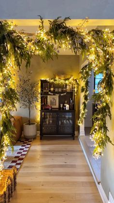 the hallway is decorated with christmas lights and greenery