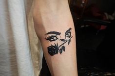 a woman's face with leaves on her left arm and the eye is drawn in black ink