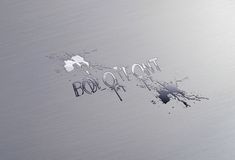 the word foil out is written in silver on a metal surface with scratches and blotches