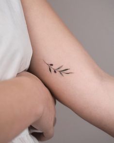 a woman with a small tattoo on her arm