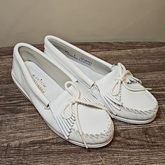 Women's Minnetonka Moccasins. Style #204. White Smooth Leather. White Closed Toe Moccasins With Rubber Sole, Comfortable White Slip-on Moccasins, Comfortable White Moccasins With Round Toe, White Comfortable Round Toe Moccasins, Casual White Flat Moccasins, White Moccasins, Minnetonka Fringe Boots, Moccasin Ankle Boots, Minnetonka Boots