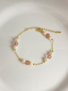 This charming bracelet is handmade with white freshwater pearls, pink strawberry crystal beads and a sturdy cable chain. The combination of pearls and crystals creates a stunning piece that adds a touch of elegance to any outfit. Freshwater pearl size is 5mm Strawberry crystal bead size is 5.8-6.2mm Bracelet length is 17+5cm As it's a handmade item please allow 2-3mm difference. Please let me know if you would like a different chain or length. Please keep them away from chemicals such as perfume, hairspray ect. Better remove before shower and swim.   The product is made by care and love 💕 Dainty Pink 14k Gold-filled Bracelets, Dainty Pink 14k Gold Filled Bracelets, Pink Dainty Pearl Bracelet, Delicate Pink Pearl Bracelet As A Gift, Delicate Pink Pearl Bracelet As Gift, Delicate Pink Pearl Bracelet For Gift, Delicate Pink Pearl Bracelet Gift, Dainty Pink Pearl Bracelets, Dainty Pink Pearl Bracelet With Pearl Charm