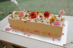 a cake decorated with flowers on a table