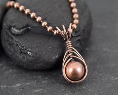 This pendant was made with copper wire, copper beads, copper chain and a copper bead.  Measurements Pendant width: 10 Millimetres; Pendant height: 23 Millimetres; Necklace length: 47 Centimetres ✩ The item comes in a branded gift box- perfect for gifting.  ✩ All items are handcrafted by myself and every effort is taken to produce a high quality product.  ✩ Copper and sterling silver jewellery care: copper and sterling silver pieces will tarnish over time. To restore the shine simply polish the piece using a jewellery polishing cloth.  ✩ If you have any questions, send me a message! I am also doing jewelry upon request, so if you have an idea of what you'd like me to make for you, please get in touch to talk about it! Copper Beaded Chain Jewelry Gift, Copper Beaded Chain Jewelry As Gift, Copper Beaded Chain Jewelry For Gifts, Copper Necklaces With Round Beads For Gift, Rose Gold Copper Pendant Necklace, Rose Gold Copper Round Pendant Necklace, Rose Gold Copper Wire Wrapped Necklaces, Antique Copper Jewelry, Diy Pendants