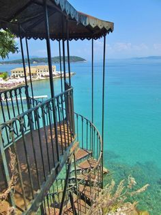 a spiral staircase leading down to the ocean