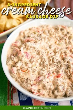 a white bowl filled with dip next to a plate of chips on a colorful table cloth