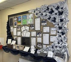 a bulletin board covered in pictures and writing on it's side, with several plaques attached to the wall