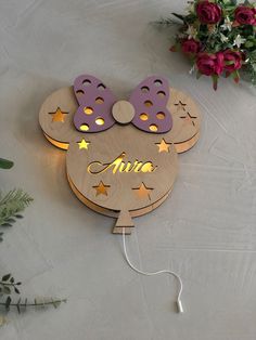 a wooden sign with two minnie mouse ears on it's face and the word name